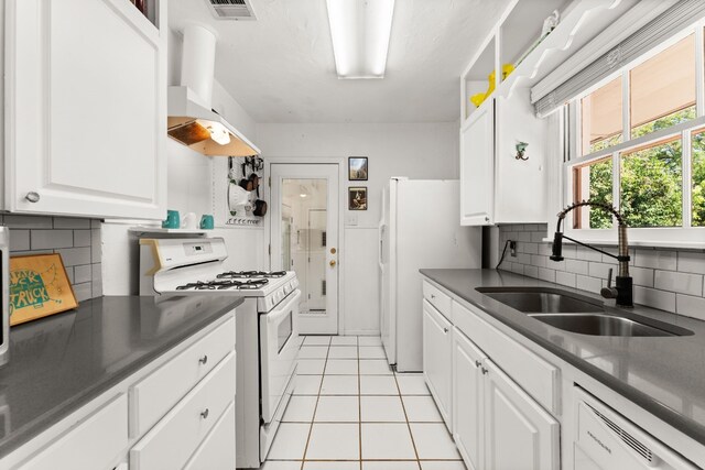 7909 Tisdale Dr, Austin, TX 78757 - kitchen featuring white appliances, a sink, range hood, white cabinets, and decorative backsplash