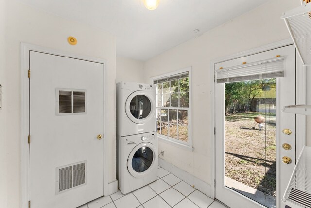 7909 Tisdale Dr, Austin, TX 78757 - washroom featuring stacked washer and clothes dryer and light tile patterned floors
