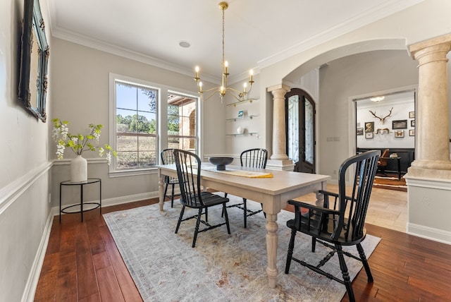 7409 Lantern View Dr, Jonestown, TX 78645 - dining area featuring decorative columns, arched walkways, dark wood finished floors, and ornamental molding