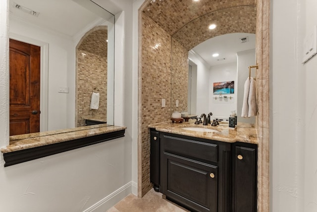 bathroom with tile patterned floors, vanity, and ornamental molding