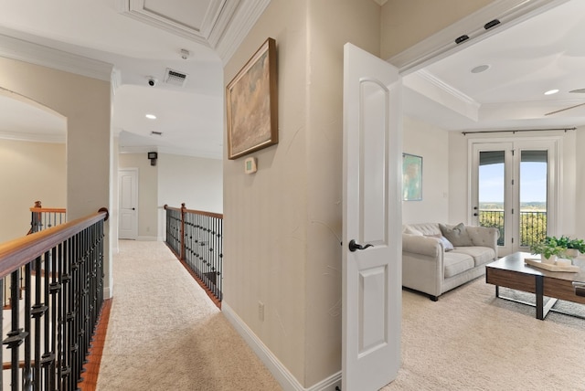 hallway featuring crown molding and light colored carpet