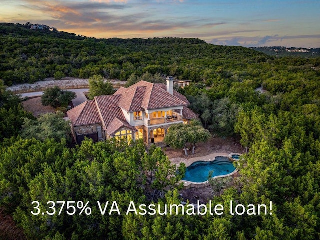 7409 Lantern View Dr, Jonestown, TX 78645 - aerial view of property and surrounding area with a forest and a pool area