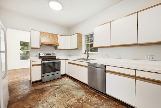 kitchen featuring white cabinetry, sink, appliances with stainless steel finishes, and a wealth of natural light