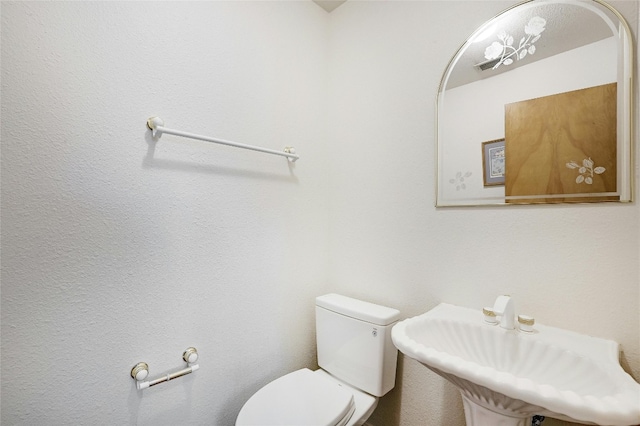 bathroom with toilet and sink