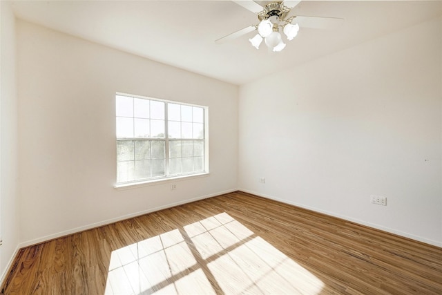 spare room featuring hardwood / wood-style floors and ceiling fan