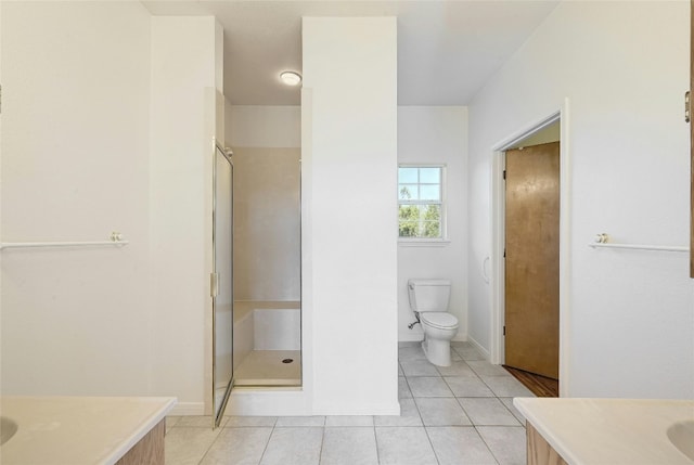 bathroom with tile patterned flooring, vanity, toilet, and an enclosed shower