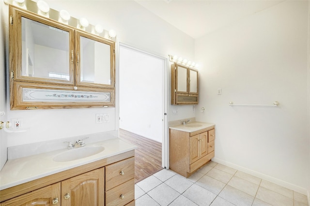 8302 N Madrone Trl, Austin, TX 78737 - bathroom with two vanities, tile patterned floors, and baseboards