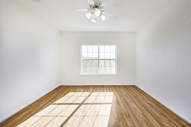 empty room with ceiling fan and wood-type flooring