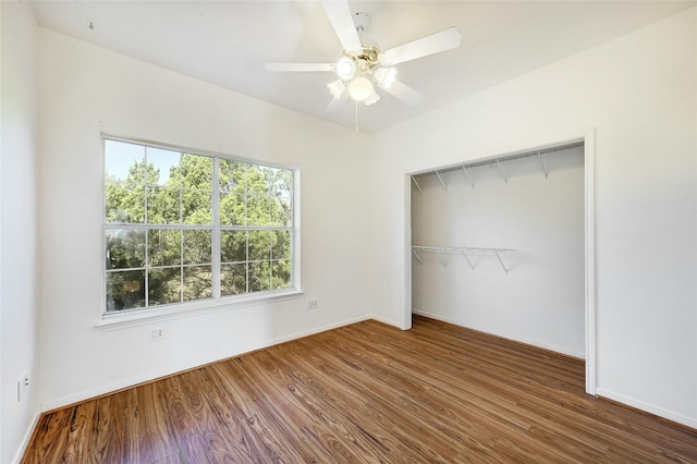 unfurnished bedroom featuring a closet, ceiling fan, and dark hardwood / wood-style floors