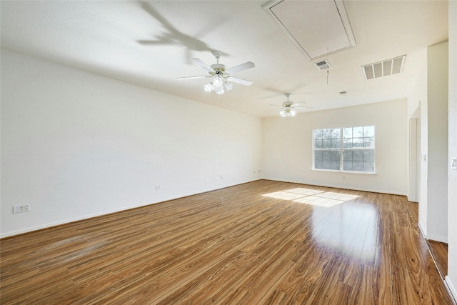 8302 N Madrone Trl, Austin, TX 78737 - empty room featuring attic access, wood finished floors, a ceiling fan, and baseboards