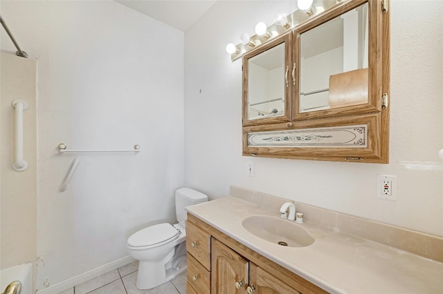 bathroom with toilet, vanity, and tile patterned floors