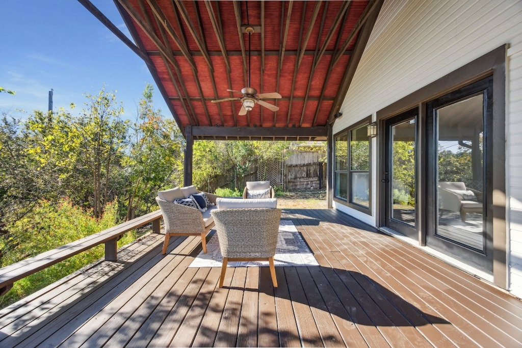 wooden deck featuring outdoor lounge area and ceiling fan