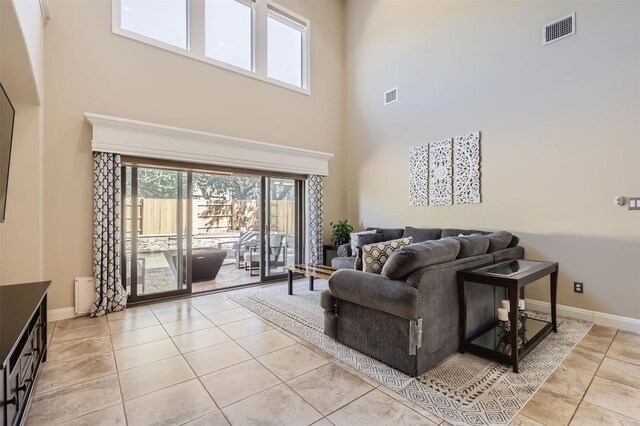 tiled living room with a towering ceiling