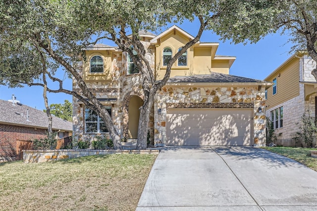 mediterranean / spanish-style home with a garage and a front lawn