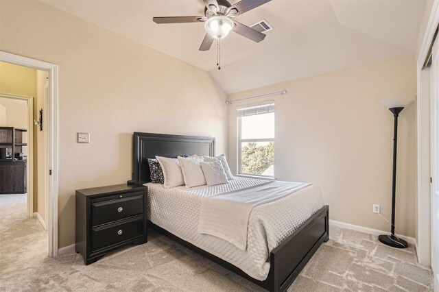 carpeted bedroom with vaulted ceiling and ceiling fan