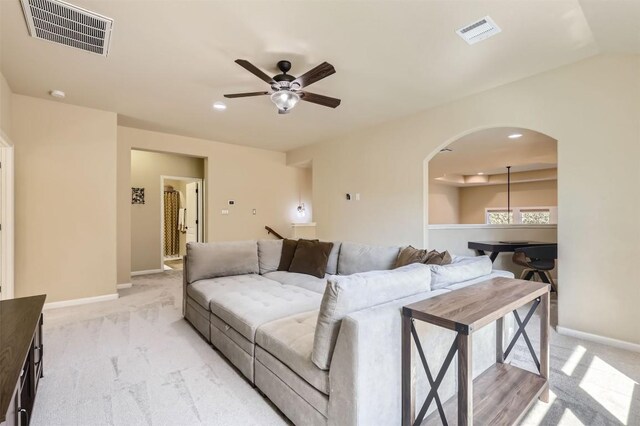 living room featuring light colored carpet and ceiling fan