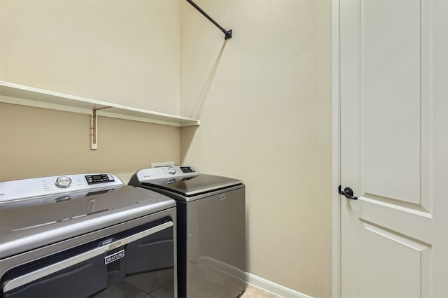 laundry area with tile patterned floors and independent washer and dryer