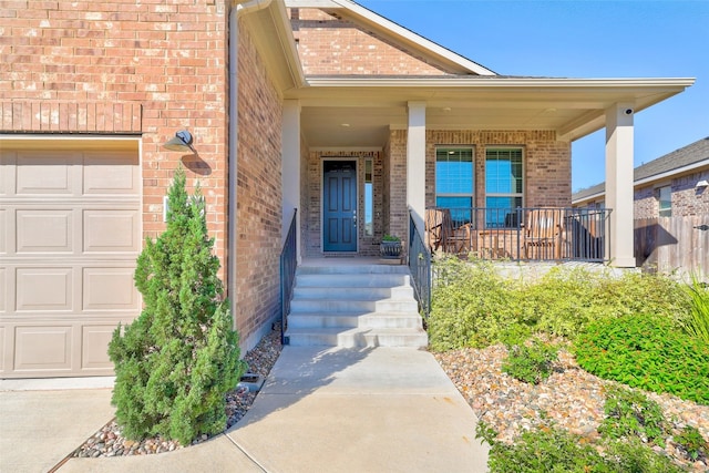 view of exterior entry featuring covered porch