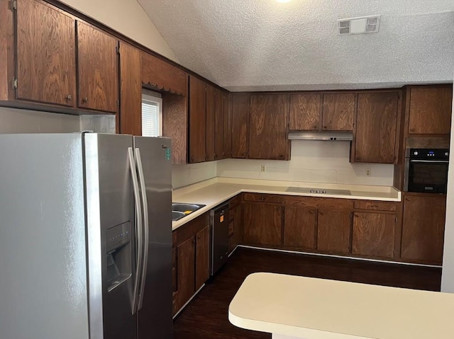 kitchen featuring a textured ceiling, dark brown cabinetry, dark wood-type flooring, and black appliances