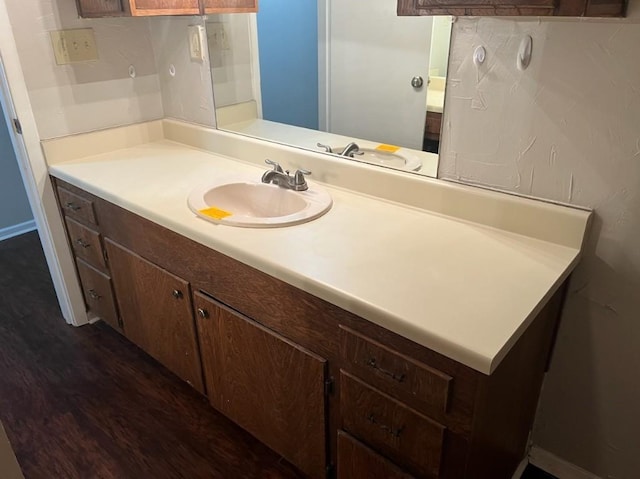 bathroom with hardwood / wood-style floors and vanity