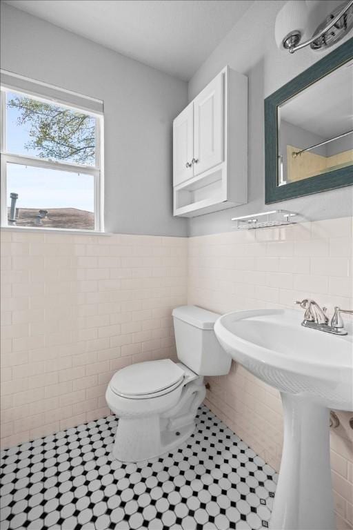 2803 Nordham Dr, Austin, TX 78745 - bathroom with tile walls, tile patterned floors, and a wainscoted wall