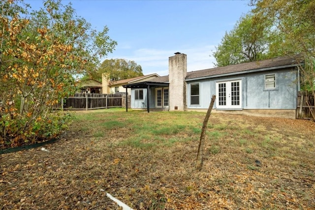 2803 Nordham Dr, Austin, TX 78745 - rear view of house with french doors, a chimney, and a fenced backyard