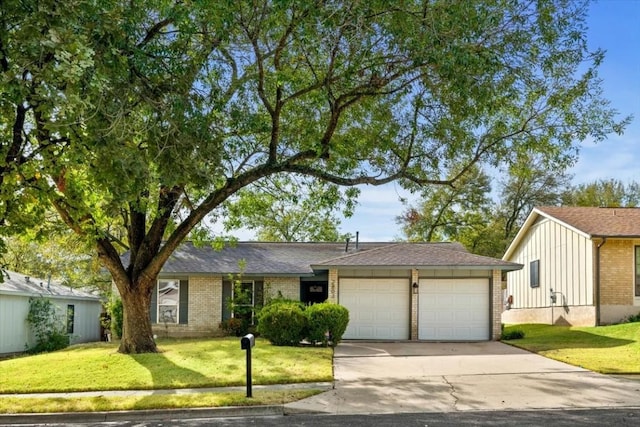 2803 Nordham Dr, Austin, TX 78745 - view of front of house with a garage, concrete driveway, brick siding, and a front lawn