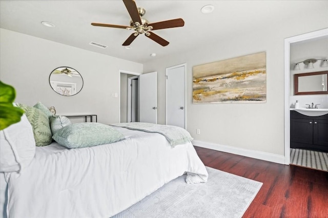 2803 Nordham Dr, Austin, TX 78745 - bedroom with dark wood finished floors, connected bathroom, ceiling fan, and recessed lighting