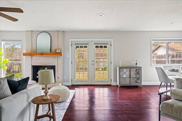 2803 Nordham Dr, Austin, TX 78745 - living area featuring wood finished floors, a ceiling fan, french doors, and a fireplace