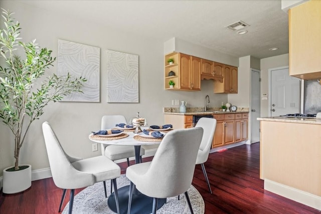 2803 Nordham Dr, Austin, TX 78745 - dining area with dark wood-type flooring and baseboards