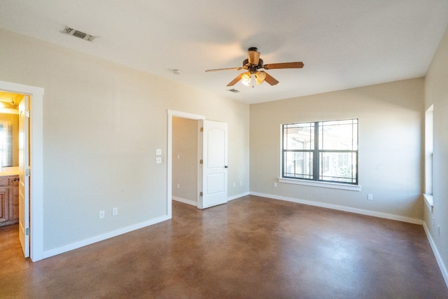 empty room with concrete flooring and ceiling fan