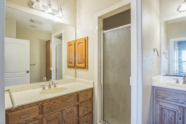 bathroom featuring vanity and a shower with door