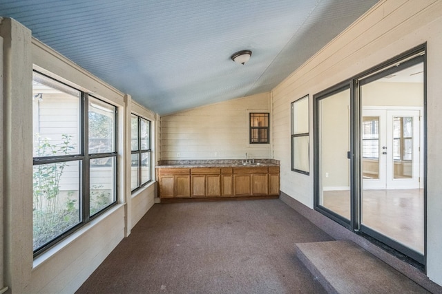 unfurnished sunroom with sink and lofted ceiling