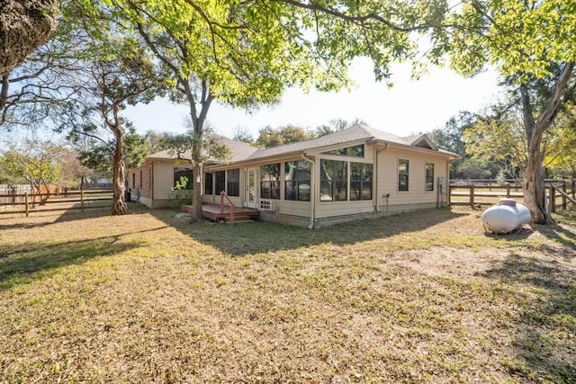 rear view of property with a yard and a wooden deck