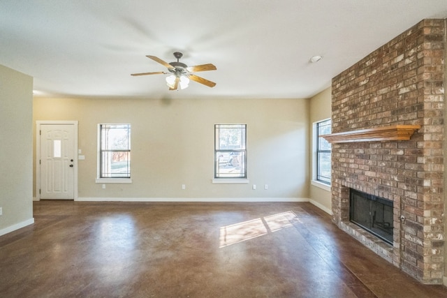 unfurnished living room featuring ceiling fan, a healthy amount of sunlight, and a fireplace