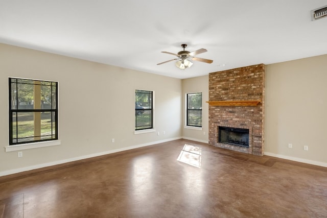 unfurnished living room with a brick fireplace and ceiling fan