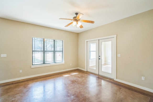 unfurnished room featuring french doors, ceiling fan, and concrete floors