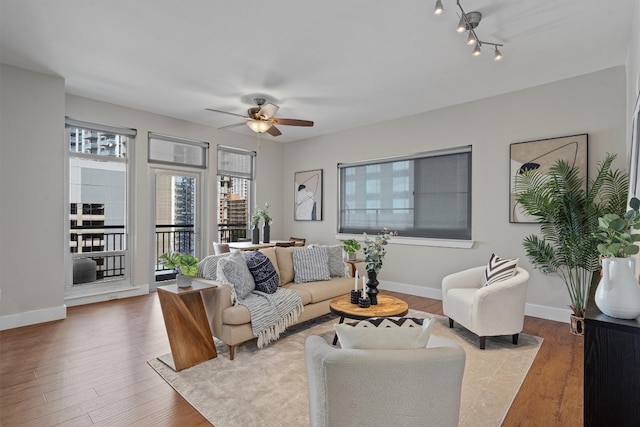 living room featuring light wood-type flooring and ceiling fan