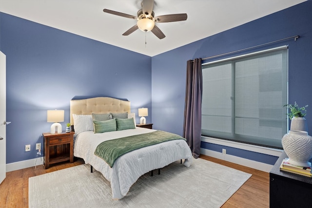 bedroom with hardwood / wood-style flooring and ceiling fan