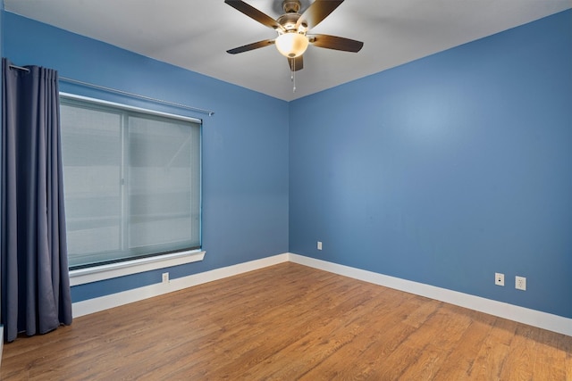 empty room with ceiling fan and wood-type flooring