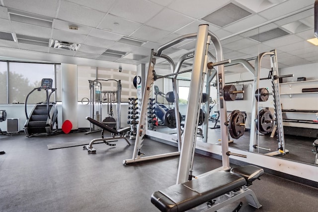 gym featuring a paneled ceiling