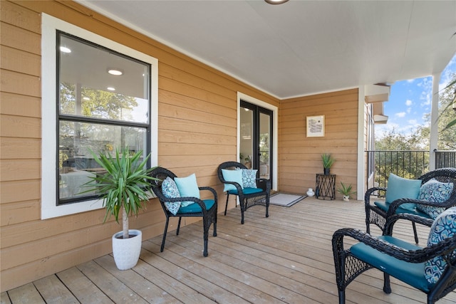 wooden deck with an outdoor living space