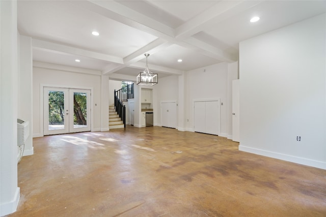 unfurnished living room featuring an AC wall unit, beam ceiling, concrete flooring, coffered ceiling, and french doors