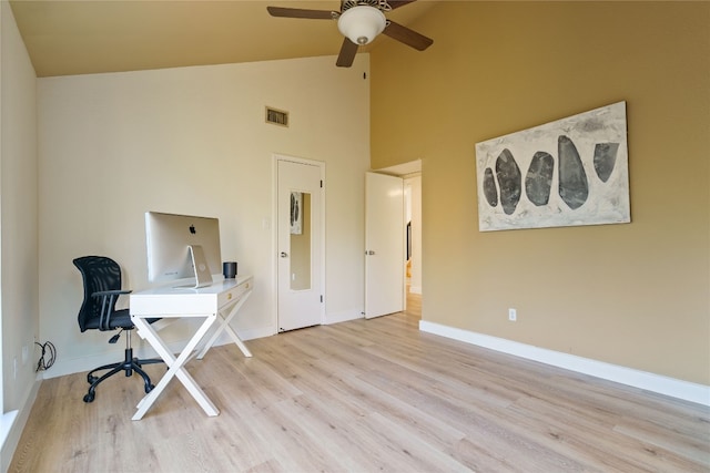 office featuring high vaulted ceiling, ceiling fan, and light wood-type flooring