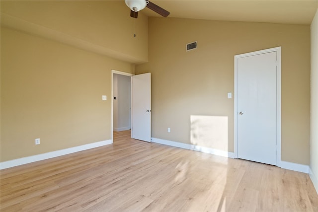 unfurnished bedroom featuring light wood-type flooring, high vaulted ceiling, and ceiling fan