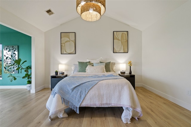 bedroom with light hardwood / wood-style floors and vaulted ceiling