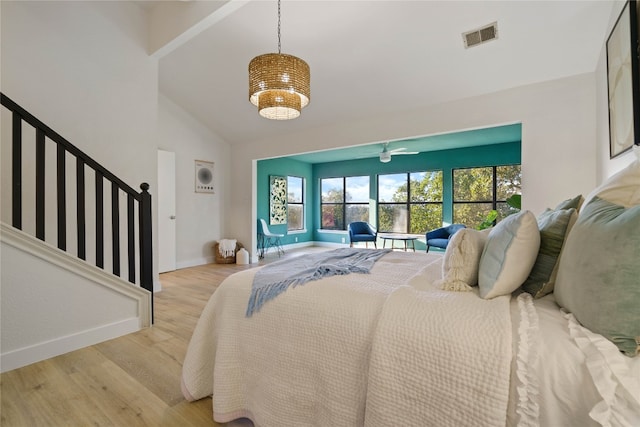 bedroom with light hardwood / wood-style flooring and lofted ceiling