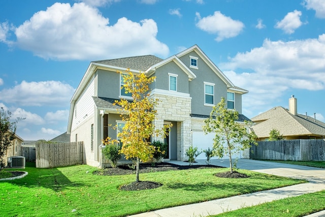 view of front of house with a front lawn, a garage, and cooling unit