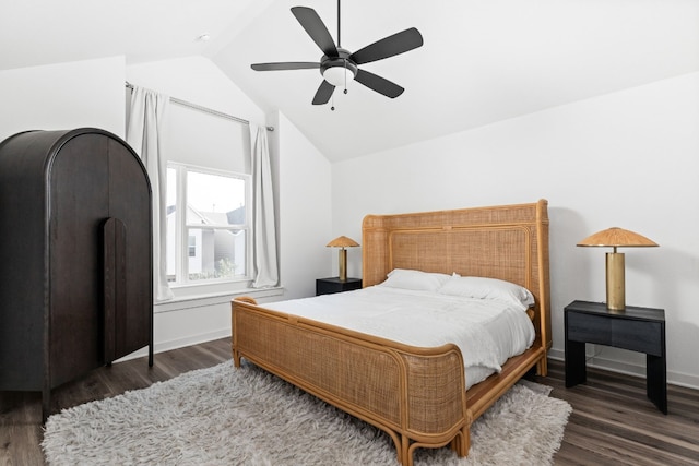 bedroom with a ceiling fan, lofted ceiling, baseboards, and wood finished floors