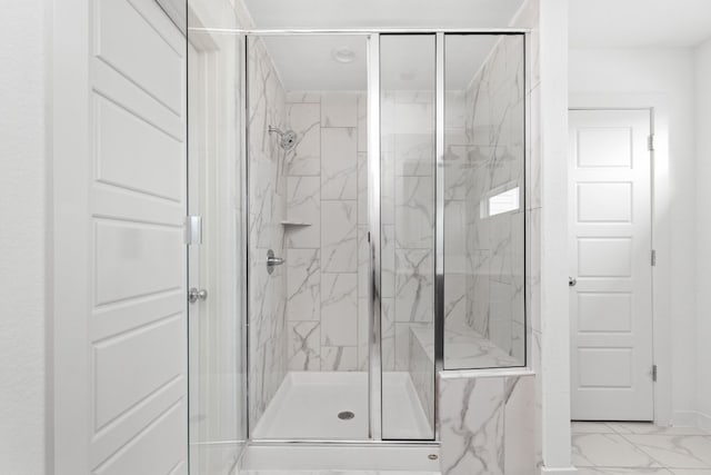 full bathroom featuring marble finish floor and a marble finish shower